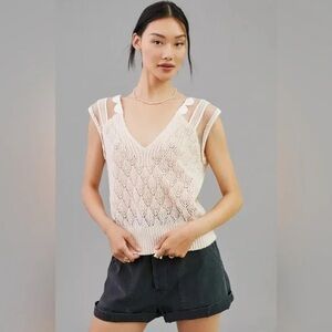 Anthropologie’s Maeve cream knit tank with sheer sleeves